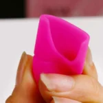 Pink silicone object held in hand
